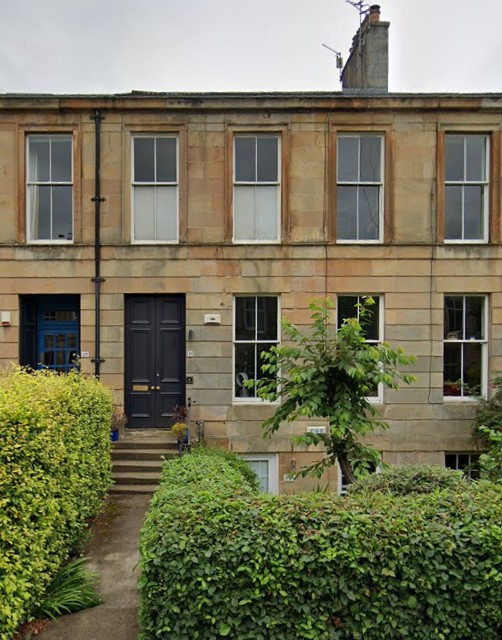 Flat-fronted mid-terrace sandstone house