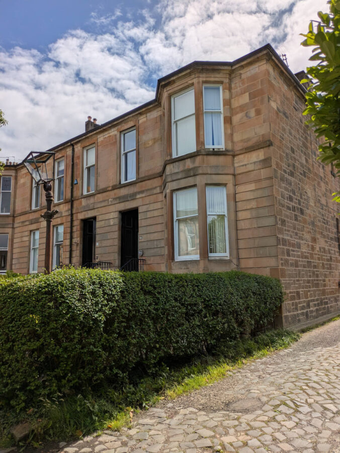 Sandstone end terrace -storey house, with a somewhat dilapidated Victorian lamp standard outside