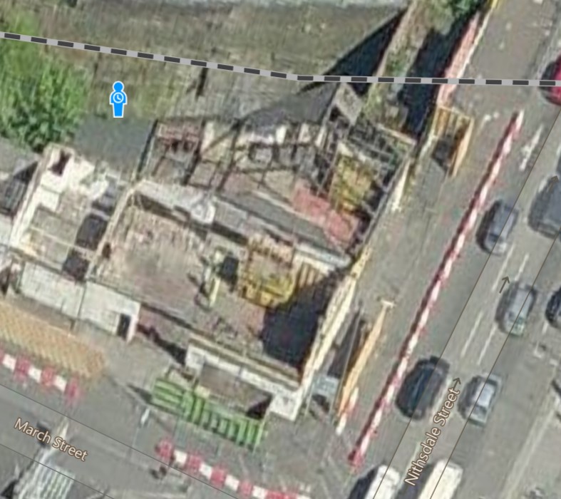 Arial photo showing walls outlining the site onthe corner of March street