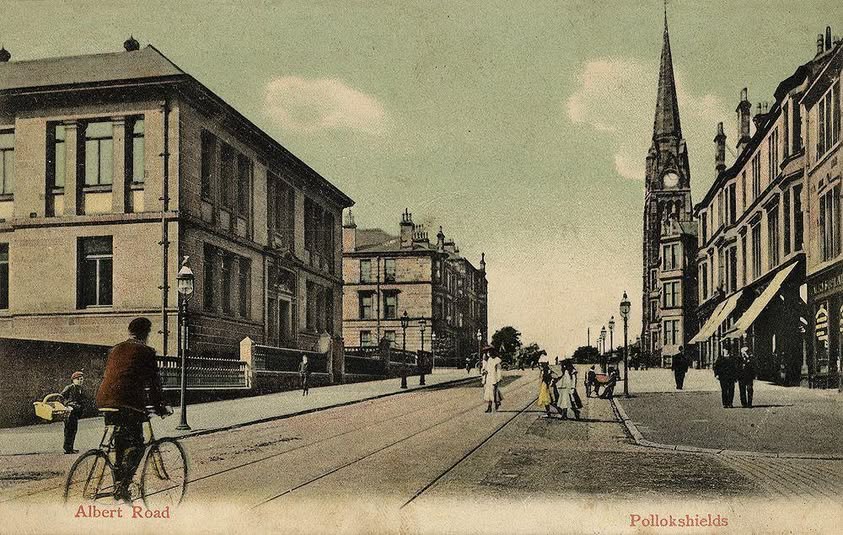 Old postcard showing street scene with church in distance