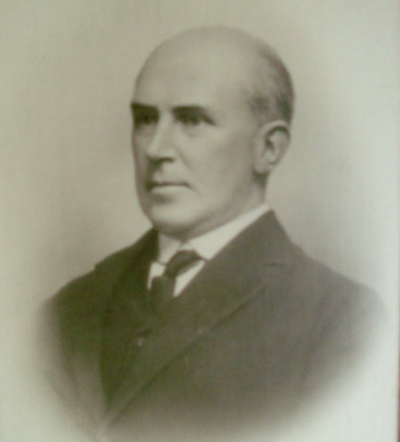 Portrait of Alphonso looking serious in suit and tie