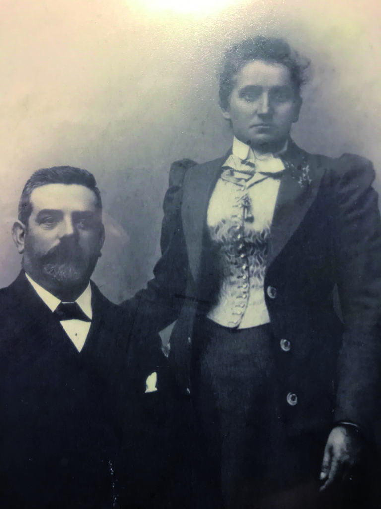 Victorian era photo, bearded man seated, wife standing beside him