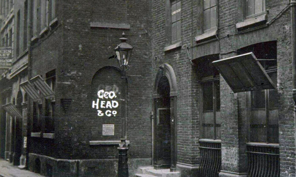 Dark narrow back alley in London. Several windows have reflectors installed on boards to reflect light into the rooms