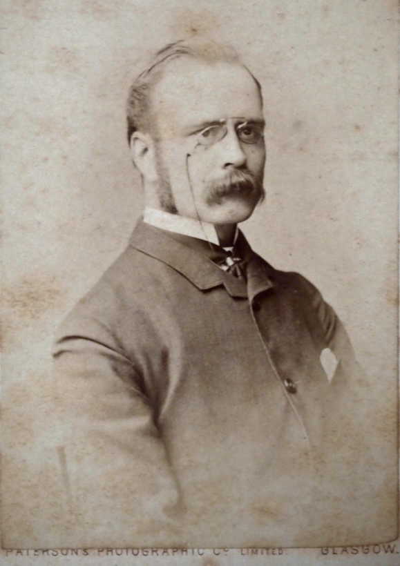 Younger gent with tash, impressive sideburns, and pince-nez glasses