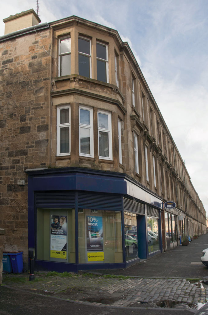 Tenement building with William Hill's shop in foreground