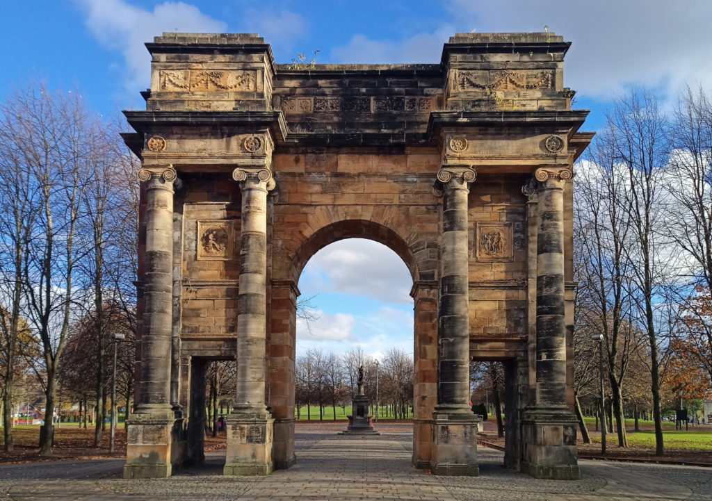 Late autumnal sun falling accross the sandstone arch at the entrance to Glasgow Green