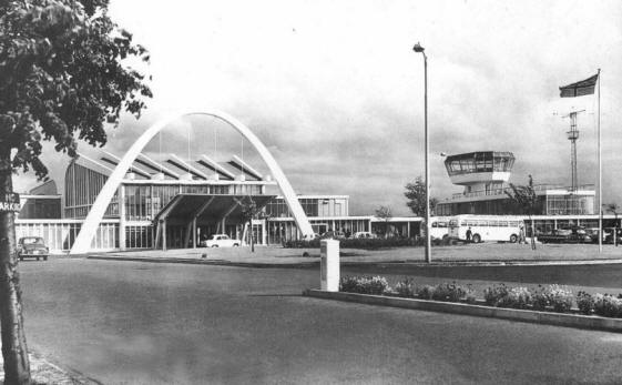 Futuristic Renfrew Terminal with parabolic arch over the entrance, and control tower to the right.