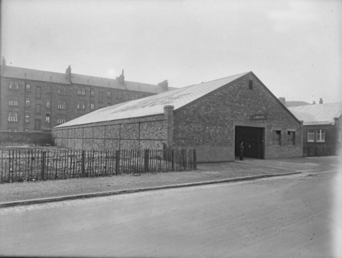 Large brick built shed with entrance off Titwood Road. "Garage" in large letters on the roof.